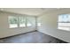 Empty room featuring hardwood floors and multiple windows for a bright living space at 147 Gobbler Dr, Smithfield, NC 27577
