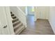 Hallway with hardwood floors, a staircase, and a view of the front door at 147 Gobbler Dr, Smithfield, NC 27577