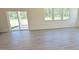 Bright living room featuring hardwood floors, a sliding glass door, and multiple windows at 147 Gobbler Dr, Smithfield, NC 27577