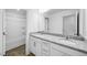 Bathroom featuring double sinks with granite countertops and a shower/tub combo with a white shower curtain at 174 Hickory Grove Dr, Sanford, NC 27330