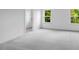 Bedroom with a walk-in closet, plush grey carpet, and natural light from two double-hung windows at 174 Hickory Grove Dr, Sanford, NC 27330