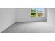 Bedroom with a plush carpet and natural light from one double-hung window and a view of a construction site at 174 Hickory Grove Dr, Sanford, NC 27330