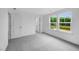 Bedroom with a plush carpet and natural light from two double-hung windows with a view of nature at 174 Hickory Grove Dr, Sanford, NC 27330