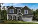 Charming two-story home featuring a welcoming front porch and a two-car garage, blending traditional and modern design elements at 174 Hickory Grove Dr, Sanford, NC 27330