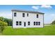 Back of home showcasing a two-story white facade, multiple windows, and a spacious green lawn at 174 Hickory Grove Dr, Sanford, NC 27330