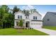 Charming two-story home with a well-manicured lawn and a two-car garage at 174 Hickory Grove Dr, Sanford, NC 27330