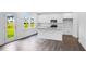 Bright kitchen with granite countertops, stainless steel appliances, and white cabinets with dark hardwood floors at 174 Hickory Grove Dr, Sanford, NC 27330
