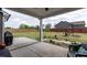 Covered back patio with a great view of the spacious yard with a fire pit at 18 Fisher Rd, Lillington, NC 27546