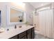 Bathroom with marble countertops, an ornate mirror, and vanity at 18 Fisher Rd, Lillington, NC 27546