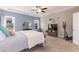 Cozy bedroom featuring carpet, a ceiling fan, and a large sunny window at 18 Fisher Rd, Lillington, NC 27546
