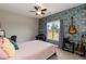 Cheerful bedroom showcasing stylish wallpaper, a ceiling fan, and a large window at 18 Fisher Rd, Lillington, NC 27546