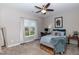 Inviting bedroom featuring a ceiling fan, neutral walls, and bright window at 18 Fisher Rd, Lillington, NC 27546