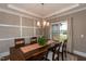 Bright dining room featuring a decorative chandelier, neutral walls, and seating for six at 18 Fisher Rd, Lillington, NC 27546