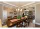 Open-concept dining room flowing into the living area; complete with chandelier, rug, and seating for six at 18 Fisher Rd, Lillington, NC 27546