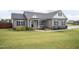 Inviting single-story home with manicured lawn and a charming covered porch at 18 Fisher Rd, Lillington, NC 27546