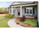 Well-maintained home with a charming front yard, walkway, and inviting porch seating at 18 Fisher Rd, Lillington, NC 27546