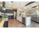 Modern kitchen with a large island, stainless steel appliances, and a view to the living area at 18 Fisher Rd, Lillington, NC 27546