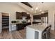 Well-appointed kitchen with an island, dark wood cabinets, stainless steel appliances, and pantry access at 18 Fisher Rd, Lillington, NC 27546