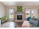 Cozy living room with fireplace, flanked by windows overlooking the backyard and a comfortable seating area at 18 Fisher Rd, Lillington, NC 27546
