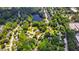 Wide aerial shot of a neighborhood with tree-lined streets and a peaceful lake at 1816 Albacore Ln, Raleigh, NC 27612