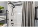 Bathroom featuring shower with gray curtain, updated fixtures, and shelving at 1816 Albacore Ln, Raleigh, NC 27612