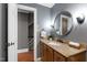 Bathroom featuring wood vanity with granite counters and updated fixtures at 1816 Albacore Ln, Raleigh, NC 27612