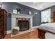 Bedroom featuring fireplace with mantel, hardwood flooring, and neutral paint at 1816 Albacore Ln, Raleigh, NC 27612