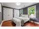 Neutral bedroom with two windows, white trim, wood flooring and double closets at 1816 Albacore Ln, Raleigh, NC 27612