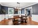 Elegant dining room with a wooden table, bench seating, and stylish chandelier at 1816 Albacore Ln, Raleigh, NC 27612