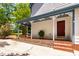 Charming front porch with brick steps and decorative trim, offering curb appeal and an inviting entrance at 1816 Albacore Ln, Raleigh, NC 27612