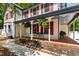 Inviting front porch with brick flooring, detailed columns, and ample seating space at 1816 Albacore Ln, Raleigh, NC 27612