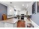 Well-lit kitchen with white cabinets, stainless steel appliances, and stylish countertops at 1816 Albacore Ln, Raleigh, NC 27612