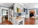 Kitchen with desk, storage and view into dining room and living room with brick fireplace at 1816 Albacore Ln, Raleigh, NC 27612