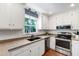 Bright kitchen featuring white cabinets, stainless steel appliances, and a double sink at 1816 Albacore Ln, Raleigh, NC 27612