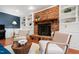 Living room showcases brick fireplace and built-in shelves, creating a cozy ambiance at 1816 Albacore Ln, Raleigh, NC 27612