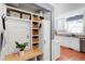 Mud room with storage shelves, cabinets, bench, and view of the kitchen at 1816 Albacore Ln, Raleigh, NC 27612