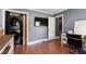 Well-lit office with hardwood floors, a desk, and a convenient, hidden washer/dryer combo at 1816 Albacore Ln, Raleigh, NC 27612