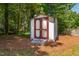 Storage shed with double doors, nestled among pine trees at 1816 Albacore Ln, Raleigh, NC 27612