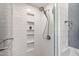 Updated shower with subway tile, glass door, and built-in shelving at 1816 Albacore Ln, Raleigh, NC 27612