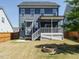Back exterior showcasing a fenced backyard with a patio, porch, and fire pit providing a delightful outdoor space at 1941 Bright Kannon Way, Wendell, NC 27591