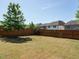 Fenced backyard with mature tree, fire pit, and ample room for outdoor activities and relaxation at 1941 Bright Kannon Way, Wendell, NC 27591