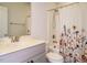Bathroom with grey vanity, and bathtub and shower with floral curtain at 1941 Bright Kannon Way, Wendell, NC 27591