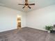 Expansive bedroom with neutral carpet, ceiling fan, and ensuite bathroom entrance providing a seamless transition at 1941 Bright Kannon Way, Wendell, NC 27591