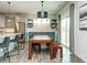Bright dining area with wooden table, bench, kitchen island and slider to outside patio at 1941 Bright Kannon Way, Wendell, NC 27591