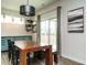Stylish dining area with a large table, modern light fixture, and sliding doors to the backyard at 1941 Bright Kannon Way, Wendell, NC 27591