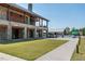 A multi-story building with stone and wood accents, overlooking a lawn and pool area at 1941 Bright Kannon Way, Wendell, NC 27591