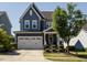 Charming two-story home featuring a two-car garage, landscaped front yard, and covered front porch at 1941 Bright Kannon Way, Wendell, NC 27591