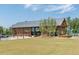 A modern farmhouse-style building with wood and metal accents, a manicured lawn, and a parking area at 1941 Bright Kannon Way, Wendell, NC 27591