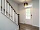 Bright foyer featuring hardwood floors, a staircase with white railings, and a stylish light fixture at 1941 Bright Kannon Way, Wendell, NC 27591