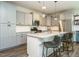 Open kitchen features grey cabinets, granite countertops and stainless steel appliances at 1941 Bright Kannon Way, Wendell, NC 27591